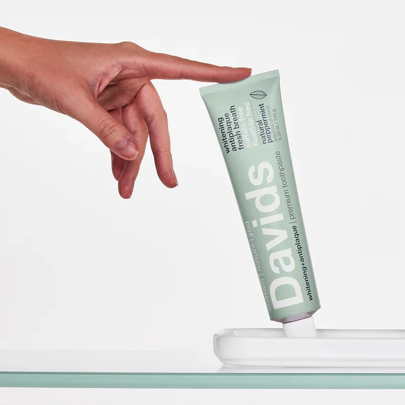 hand-reaching-for-davids-peppermint-toothpaste.jpg